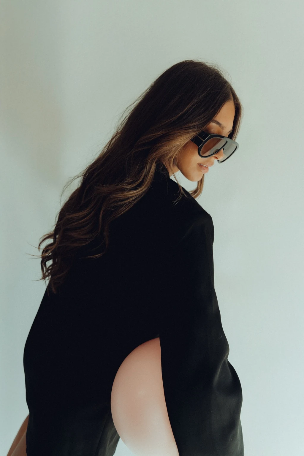 Woman in a black blazer photographed in a fashion-forward Pilates portrait